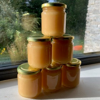6 jars of Donegal Soft Set Honey stacked on each other