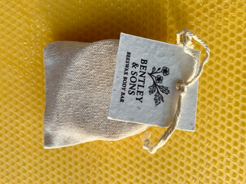 Bentley & Sons beeswax body bar in a cloth pouch with a label