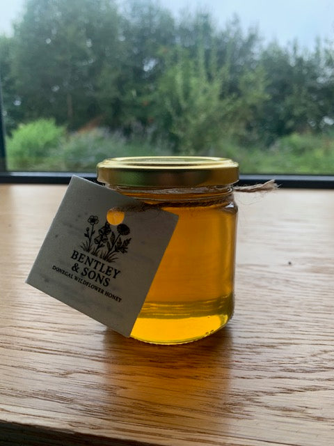 Donegal wildflower honey jar angled with golden honey inside